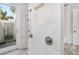 Walk-in shower with marble tile and glass door at 1810 Wisteria St, Sarasota, FL 34239