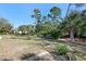 Landscaped backyard with lush greenery and mature trees at 18314 Koala Ave, Port Charlotte, FL 33948