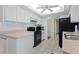 Kitchen with white cabinets, black appliances, and light countertops at 18314 Koala Ave, Port Charlotte, FL 33948