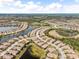 Aerial view of a luxury community with lakes, houses, and lush landscaping at 20289 Benissimo Dr, Venice, FL 34293