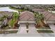 Aerial view of two-unit home with tile roofs, two-car garages, and landscaped yards at 20289 Benissimo Dr, Venice, FL 34293