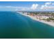 Aerial view of beach community, showing ocean, shoreline, and buildings at 20289 Benissimo Dr, Venice, FL 34293