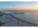 Aerial view of beach, pier, and ocean at sunset at 20289 Benissimo Dr, Venice, FL 34293