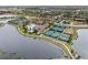 Aerial view of community with lake, tennis courts, and clubhouse at 20289 Benissimo Dr, Venice, FL 34293