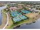 Aerial view of community with tennis courts, pickleball courts, and clubhouse at 20289 Benissimo Dr, Venice, FL 34293