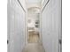 View down long hallway to bathroom with double sinks and soaking tub at 20289 Benissimo Dr, Venice, FL 34293