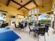 Outdoor patio area with tables, chairs, and ping pong table at 20289 Benissimo Dr, Venice, FL 34293