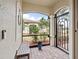 Screened-in entryway with a bench, potted plant, and view of the backyard at 20289 Benissimo Dr, Venice, FL 34293