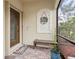 Covered entryway with a bench, potted plant, and screened enclosure at 20289 Benissimo Dr, Venice, FL 34293