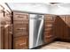 Stainless steel dishwasher built into wood cabinets at 20289 Benissimo Dr, Venice, FL 34293