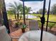 Enjoy serene lake views from this screened patio, complete with seating and lush landscaping at 20289 Benissimo Dr, Venice, FL 34293