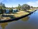 Aerial view of waterfront home with private dock and lush landscaping at 207 Waterway Ne Cir, Port Charlotte, FL 33952