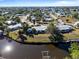 An aerial view showcasing a waterfront home with private dock and canal access at 207 Waterway Ne Cir, Port Charlotte, FL 33952