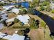 An aerial view showcasing a single-story home situated on a waterfront property at 207 Waterway Ne Cir, Port Charlotte, FL 33952