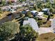 Aerial view showing home's location on a canal, surrounded by other houses at 207 Waterway Ne Cir, Port Charlotte, FL 33952