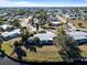 Aerial view of a waterfront property featuring a single-story house and shed at 207 Waterway Ne Cir, Port Charlotte, FL 33952