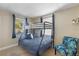 Cozy bedroom with a bunk bed and a comfortable chair at 207 Waterway Ne Cir, Port Charlotte, FL 33952