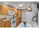 Kitchen with light wood cabinets, granite countertops, and white appliances at 207 Waterway Ne Cir, Port Charlotte, FL 33952