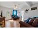 Living room with brown leather couches, wood floors, and a TV at 207 Waterway Ne Cir, Port Charlotte, FL 33952