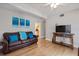 Living room with brown leather couches, wood floors, and a TV at 207 Waterway Ne Cir, Port Charlotte, FL 33952