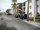 Exterior of condo building with parking lot and landscaping at 2075 Canal Dr # L36, Bradenton, FL 34207