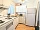 Bright condo kitchen with white cabinets and appliances at 2075 Canal Dr # L36, Bradenton, FL 34207