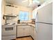 Condo kitchen with white cabinets and appliances at 2075 Canal Dr # L36, Bradenton, FL 34207