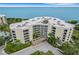 Condo building, parking area, and waterfront view at 2110 Harbourside Dr # 526, Longboat Key, FL 34228