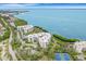 Aerial view of waterfront condo building with tennis courts at 2110 Harbourside Dr # 526, Longboat Key, FL 34228