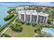 Aerial view of condo building, pool, and waterfront access at 2110 Harbourside Dr # 526, Longboat Key, FL 34228