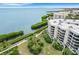 Aerial view showcasing waterfront condo and lush landscape at 2110 Harbourside Dr # 526, Longboat Key, FL 34228