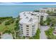 Aerial view of condo building with pool and waterfront access at 2110 Harbourside Dr # 526, Longboat Key, FL 34228