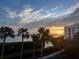 Stunning sunset over calm water with palm trees at 2110 Harbourside Dr # 526, Longboat Key, FL 34228