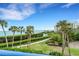 Stunning waterfront view with lush landscaping and palm trees at 2110 Harbourside Dr # 526, Longboat Key, FL 34228