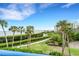 Breathtaking view of the water, lush greenery, and a tranquil path at 2110 Harbourside Dr # 526, Longboat Key, FL 34228