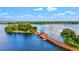 Picturesque aerial view of a lake with a wooden dock and surrounding lush greenery at 2138 Floyd St, Sarasota, FL 34239