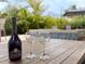 Elegant outdoor scene with wine and glasses overlooking the pool and garden at 2138 Floyd St, Sarasota, FL 34239