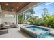 Beautiful backyard with a modern pool, comfortable seating, and lush tropical landscaping at 2138 Floyd St, Sarasota, FL 34239