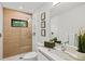 Modern bathroom with a wood-paneled shower, vessel sink and floating vanity at 2138 Floyd St, Sarasota, FL 34239