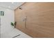 Modern shower with sleek fixtures and unique textured tile wall design at 2138 Floyd St, Sarasota, FL 34239