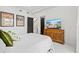 Bedroom with large bed, media console and green pillows at 2138 Floyd St, Sarasota, FL 34239