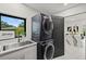 Modern laundry room with stacked washer and dryer at 2138 Floyd St, Sarasota, FL 34239