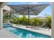 Relaxing pool area with lounge chairs and umbrella at 2138 Floyd St, Sarasota, FL 34239