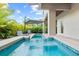 Relaxing poolside with lounge chairs and an umbrella, set against lush landscaping at 2138 Floyd St, Sarasota, FL 34239