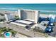 Aerial view of beachfront building with parking at 255 The Esplanade N # 506, Venice, FL 34285