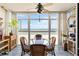 Sunroom with breathtaking ocean view, featuring a glass-top table and wicker chairs at 255 The Esplanade N # 506, Venice, FL 34285