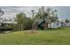 Backyard with playset, fire pit, and grassy area at 29 Mound, Terra Ceia, FL 34250