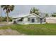 Side view of house with screened porch and grassy yard at 29 Mound, Terra Ceia, FL 34250