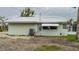 Side view of light green house showcasing window details at 29 Mound, Terra Ceia, FL 34250