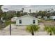 Rear view of light green house with gravel driveway at 29 Mound, Terra Ceia, FL 34250